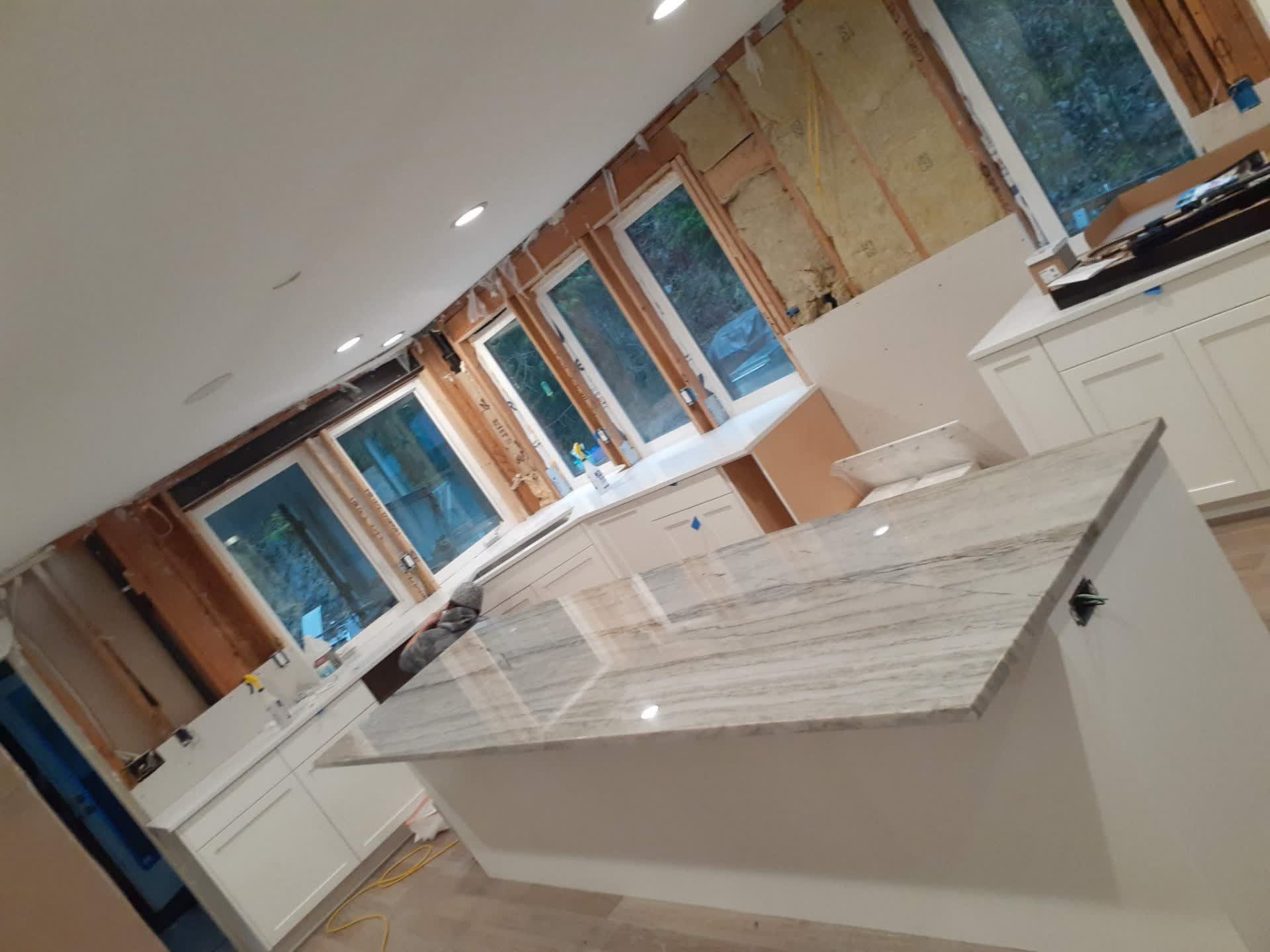 Quartzite waterfall island countertop being installed during a Bothell, WA kitchen remodel