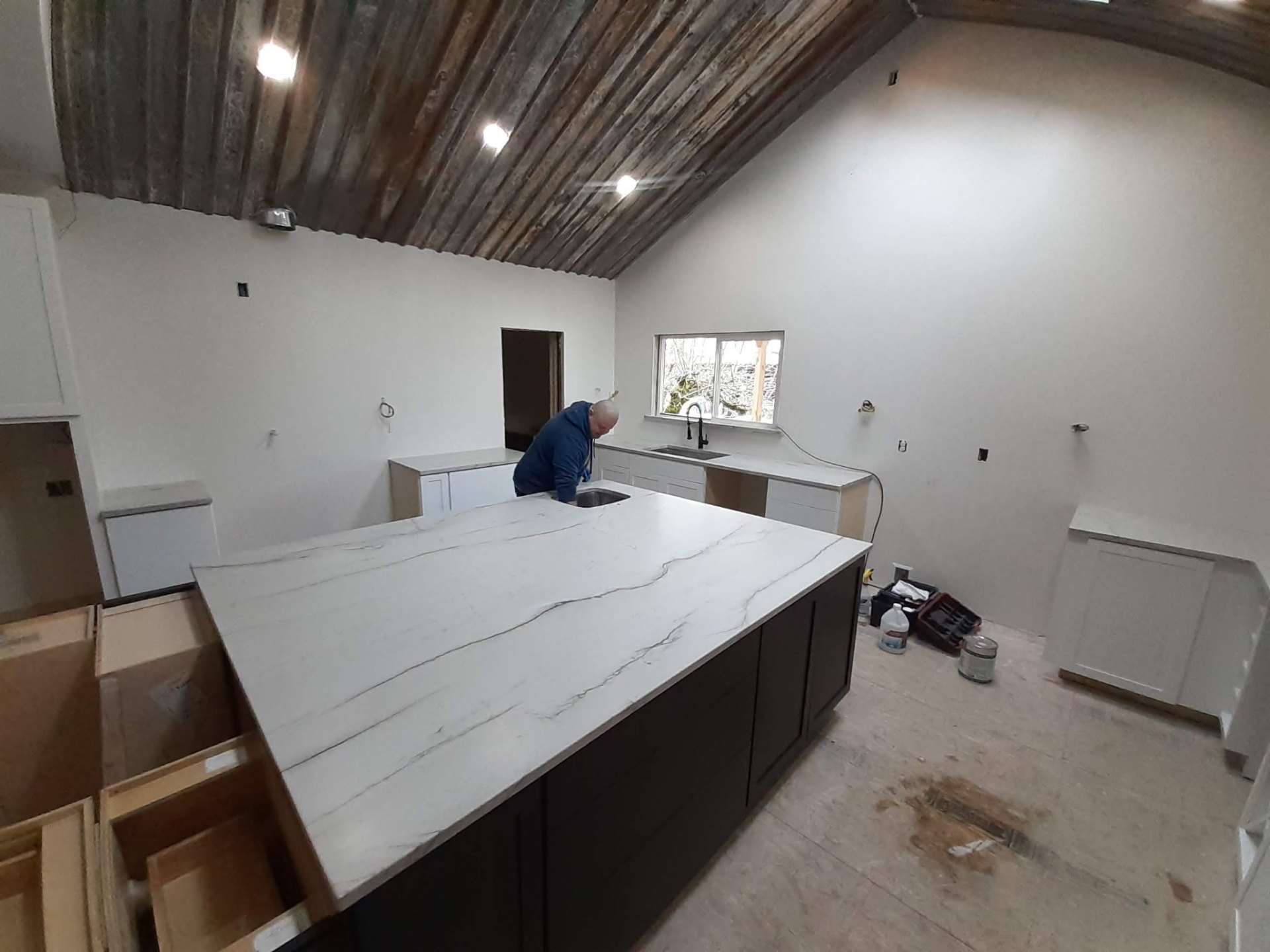 Quartz island countertop with dramatic veining being installed in a Bothell, WA kitchen remodel