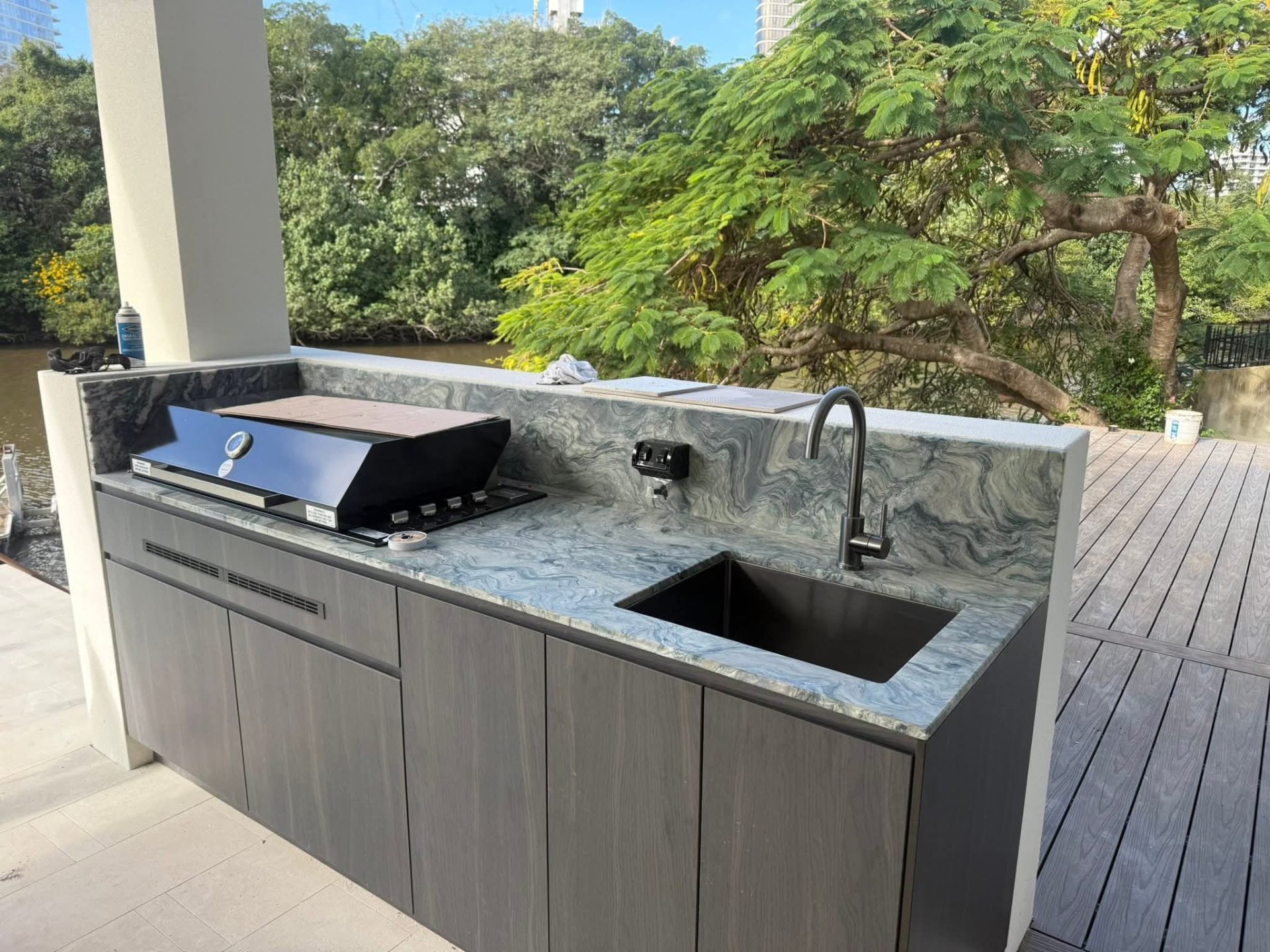 Blue-gray quartzite outdoor kitchen countertop with built-in grill and sink — Bellevue, WA